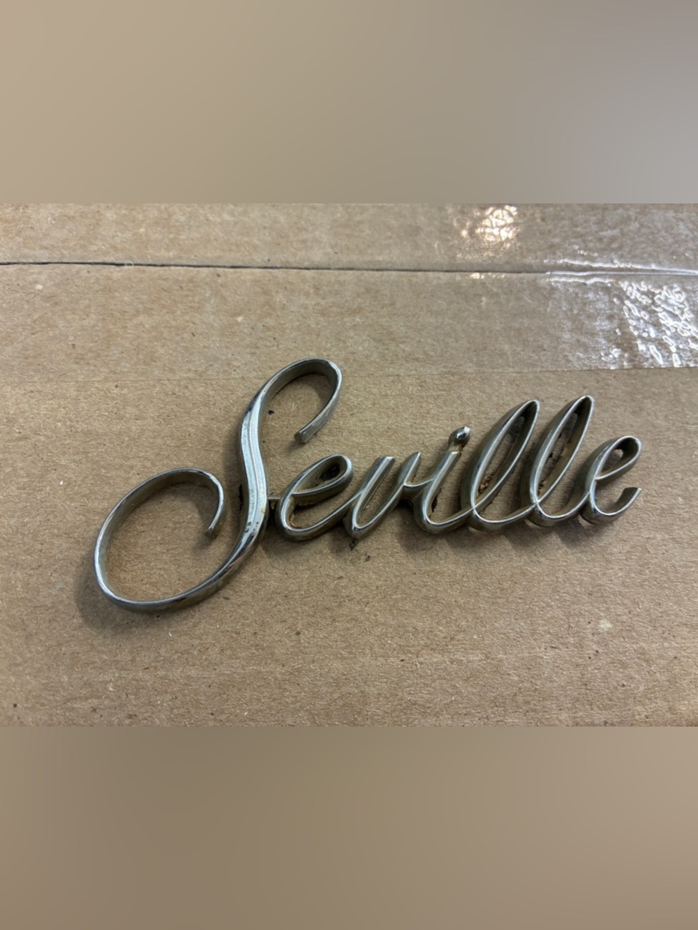 "Seville" Chrome Script Emblem